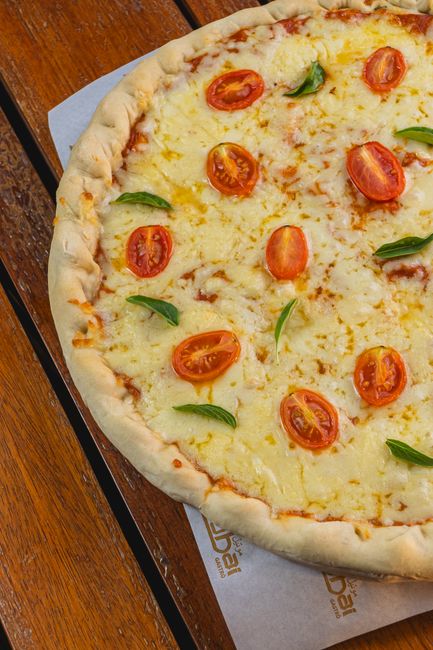 Close-up of a freshly baked margherita pizza with melted mozzarella and basil