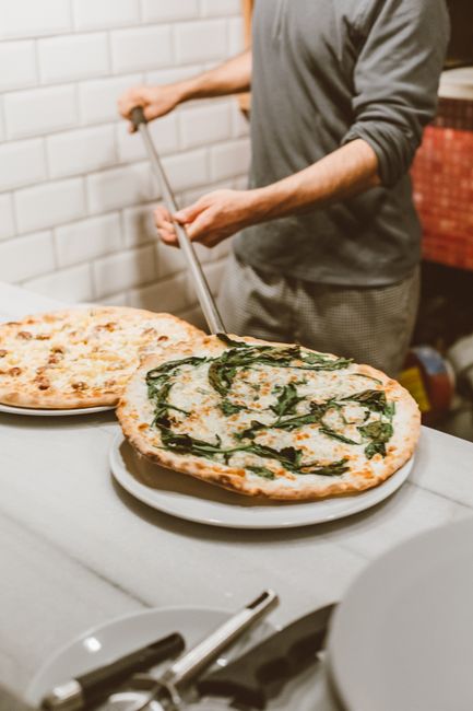 Skilled pizza chef working in a professional kitchen